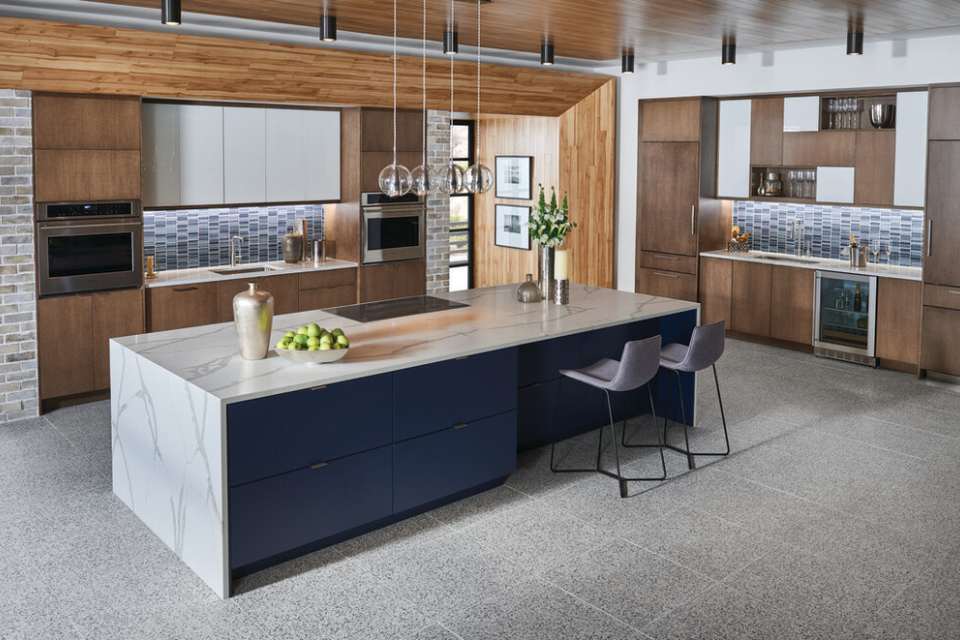 terrazzo tile in kitchen with wood cabinetry and marble island